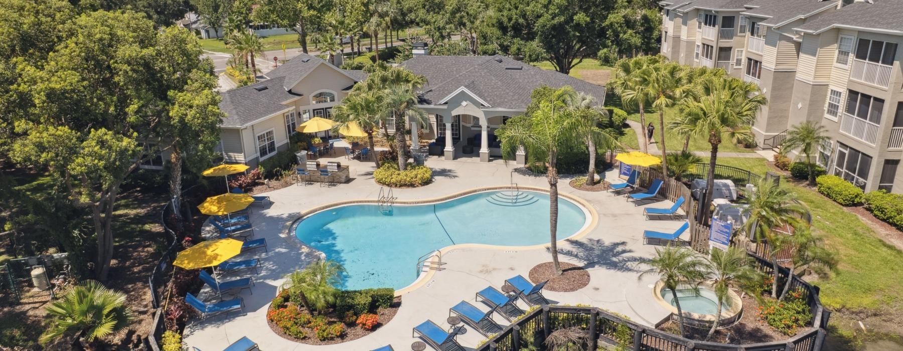 a swimming pool surrounded by trees and houses