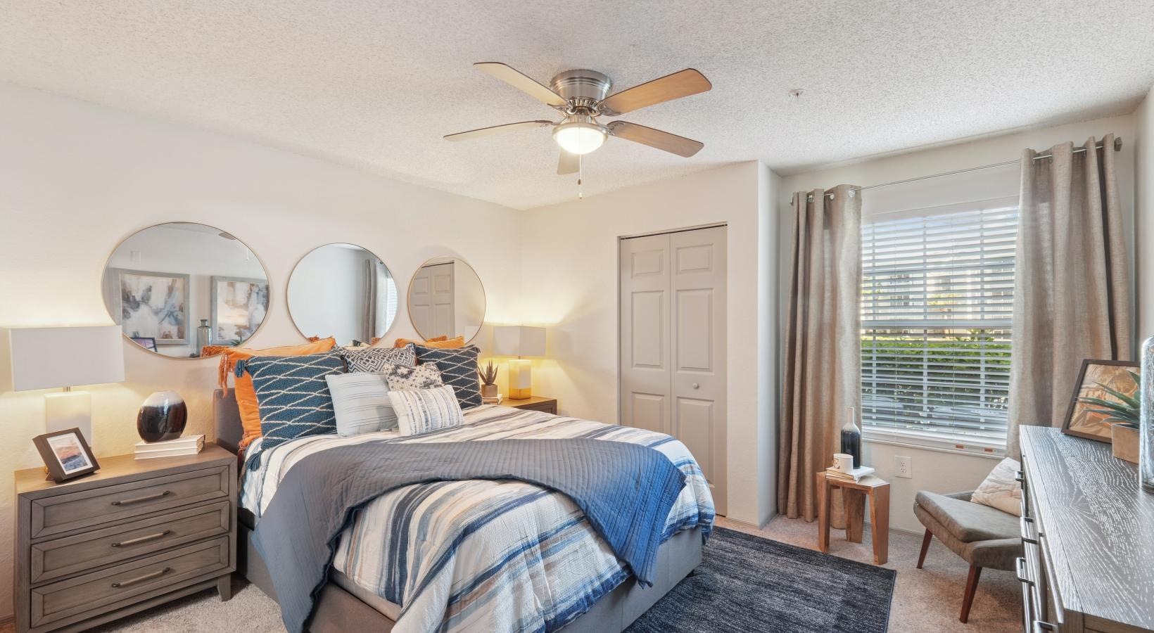 a bedroom with a bed and a fan