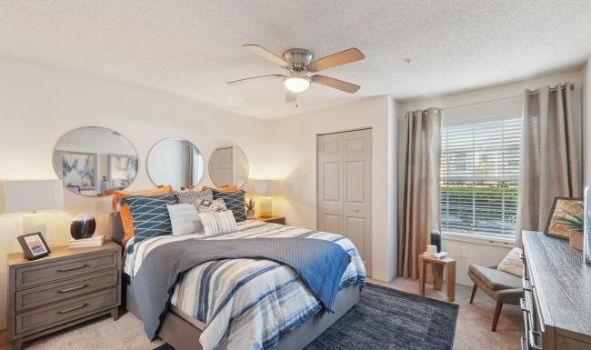 a bedroom with a bed and a fan