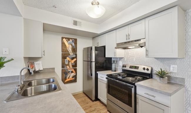 a kitchen with white cabinets